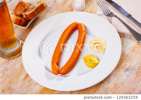 Pair of Vienna sausages with mustard and horseradish served with beer Pair of Vienna sausages with mustard and horseradish served with beer 120363259
