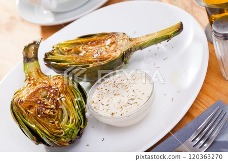 Roasted halves of artichoke with sea salt Roasted halves of artichoke with sea salt 120363270