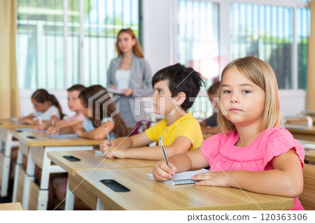 Schoolgirl sitting in classroom during lesson in elementary school Schoolgirl sitting in classroom during lesson in elementary school 120363306