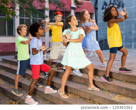 Modern cheerful tweenagers performing street dance choreography Modern cheerful tweenagers performing street dance choreography 120363362