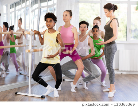 Teenage boy practicing plie position of ballet during choreography classes 120363369