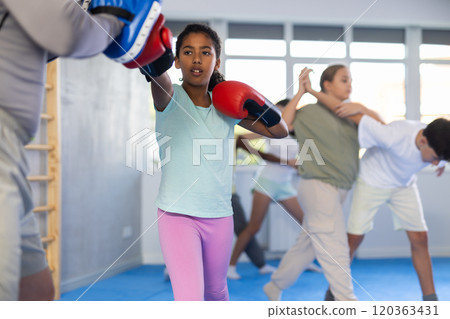 Coach and girl training boxing technique Coach and girl training boxing technique 120363431