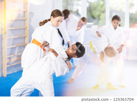 Sparring during karate training of children of different nationalities in sport gym 120363704