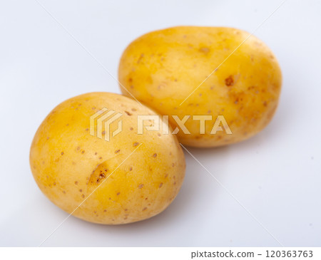 Closeup of raw yellow potatoes on white background 120363763