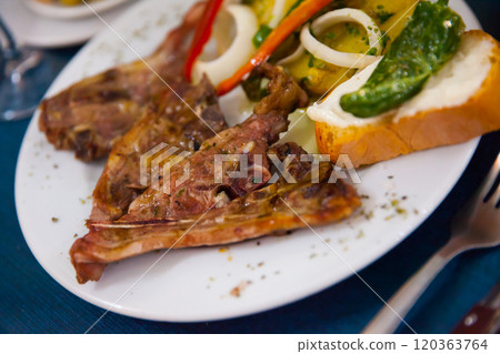 Baked under tasty lamb served with potatoes and bread Baked under tasty lamb served with potatoes and bread 120363764