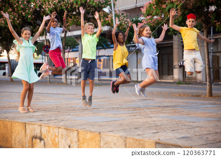 Happy tweenagers jumping on city street in summer day Happy tweenagers jumping on city street in summer day 120363771