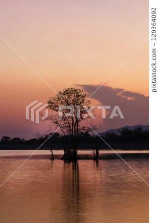 Sunset sky over the calm sea with vibrant red and orange clouds 120364092