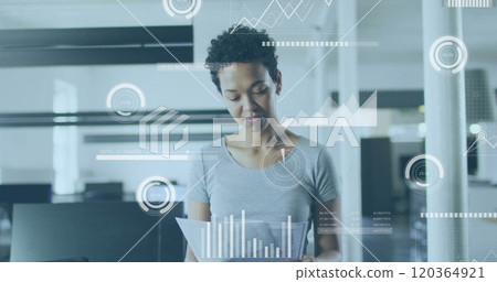 Analyzing documents, businesswoman with data visualization image over office background 120364921