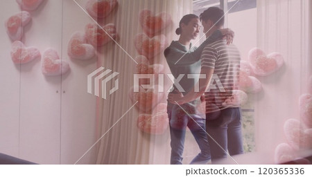 Image of love text in pink hearts over happy diverse gay male couple embracing at home Image of love text in pink hearts over happy diverse gay male couple embracing at home 120365336