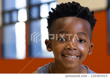Smiling boy in school classroom, looking at camera with joy and excitement 120365914