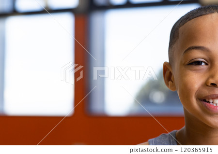 Smiling boy in school classroom, looking at camera, close-up shot, copy space 120365915