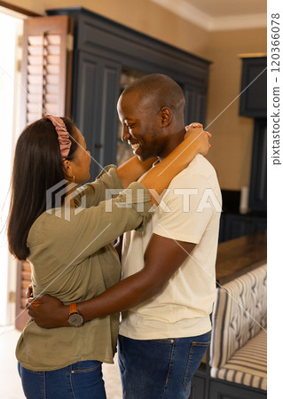 undefined embracing and smiling in kitchen, enjoying quality time together at home undefined embracing and smiling in kitchen, enjoying quality time together at home 120366078