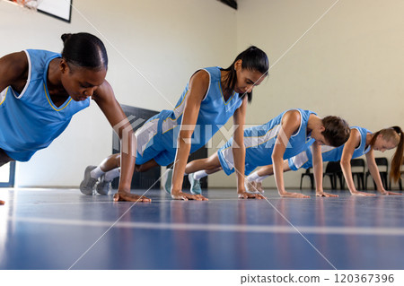 Doing push-ups on court, basketball team training in gym 120367396