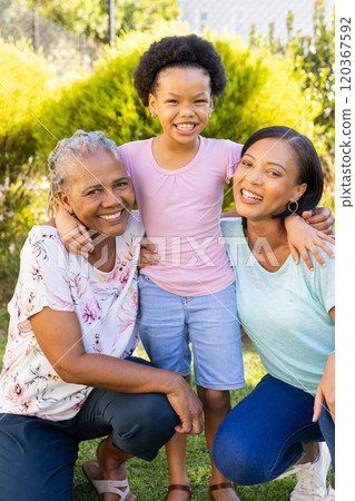 Smiling family outdoors, grandmother, mother, and daughter enjoying time together Smiling family outdoors, grandmother, mother, and daughter enjoying time together 120367592