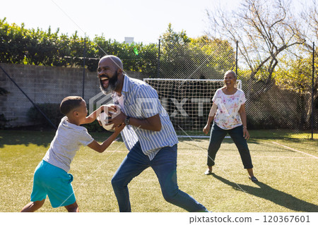 Playing football, grandparents and grandson enjoying outdoor activity on sunny day in backyard 120367601
