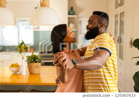 Couple dancing together in kitchen, enjoying quality time at home, in kitchen Couple dancing together in kitchen, enjoying quality time at home, in kitchen 120367633
