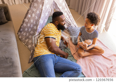 Father and daughter playing with teddy bear in homemade tent teepee at home Father and daughter playing with teddy bear in homemade tent teepee at home 120367656