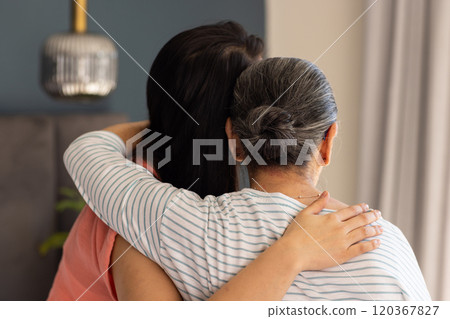 Embracing, asian grandmother and granddaughter showing support and comfort in heartfelt moment 120367827