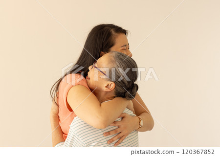 Hugging each other, asian grandmother and granddaughter sharing warm embrace Hugging each other, asian grandmother and granddaughter sharing warm embrace 120367852