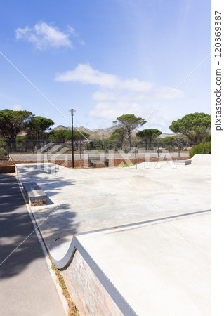 Outdoors, Empty skate park with benches and trees, ready for students to hang out Outdoors, Empty skate park with benches and trees, ready for students to hang out 120369387