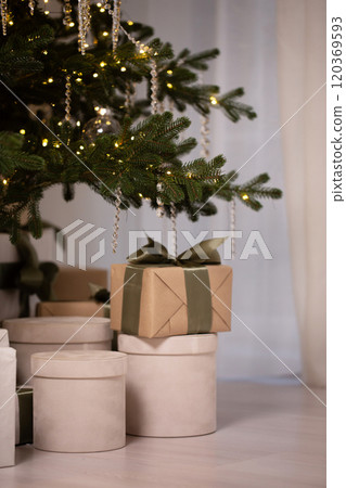 Many gift boxes with ribbons piled up under the Christmas tree 120369593