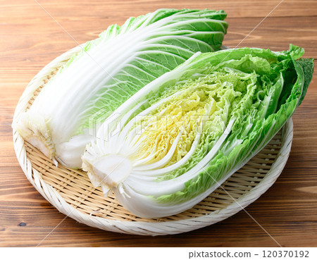 Fresh winter cabbage (half cut) on a wood grain background 120370192