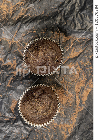 fresh and soft black chocolate cupcake on black paper 120370294