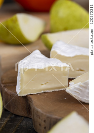 fresh cheese on a cutting board fresh cheese on a cutting board 120370311