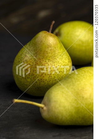 a green ripe pear on the table 120370335