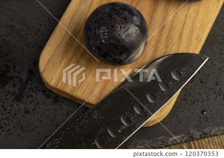 ripe purple plums close-up 120370353