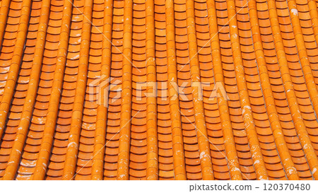 Traditional Orange Ceramic Roof Tiles with Weathered Textures in Asian Architecture 120370480