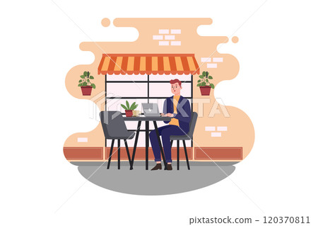 A man sitting at a cafe working on a laptop 120370811