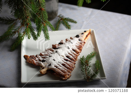 A white plate with a dessert shaped like a Christmas tree A white plate with a dessert shaped like a Christmas tree 120371188