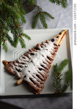A white plate with a dessert shaped like a Christmas tree A white plate with a dessert shaped like a Christmas tree 120371193