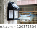 solar powered lights hanging on the fence 120371304