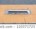 Road reflectors and cracked pavement 120371725