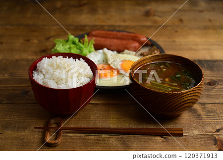 Soup and dish: fried egg and sausage 120371913