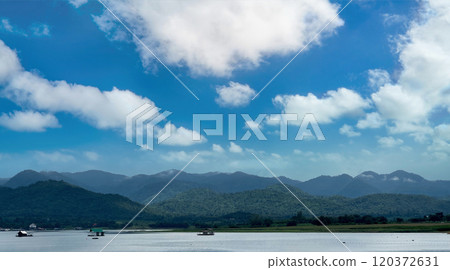 Large lake and mountain with cloudy blue sky Large lake and mountain with cloudy blue sky 120372631