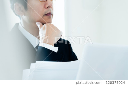 Businessman looking at materials 120373024