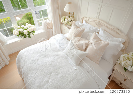 Modern bedroom with wooden accents, a white bedspread, and big window 120373350
