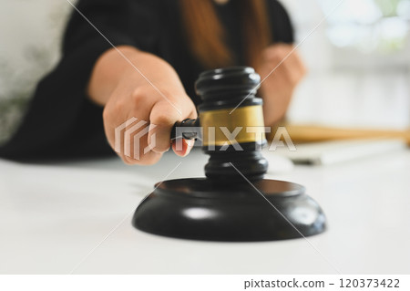 Close up of a judge hand holding gavel hammer mallet 120373422