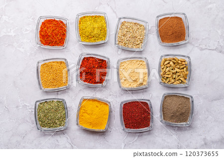 A vibrant assortment of various spices and herbs displayed together A vibrant assortment of various spices and herbs displayed together 120373655