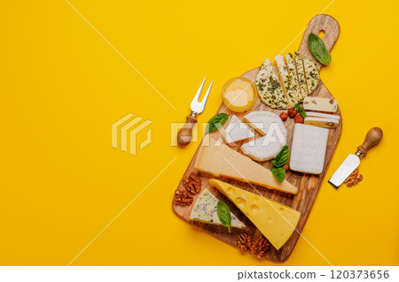 An assortment of various cheeses arranged on a board, highlighting different textures An assortment of various cheeses arranged on a board, highlighting different textures 120373656