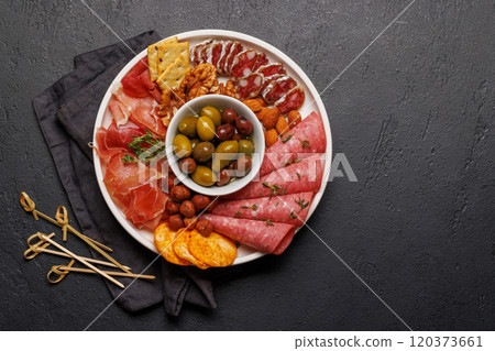 An assortment of various meats arranged on a plate, ideal for an antipasto An assortment of various meats arranged on a plate, ideal for an antipasto 120373661
