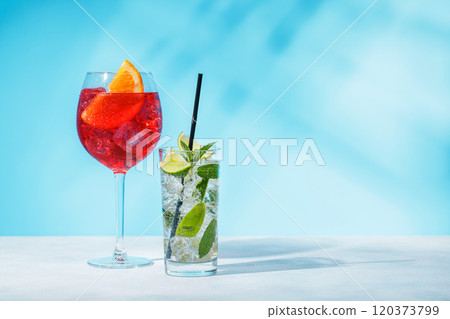 A variety of cocktails arranged on a table against a light blue background A variety of cocktails arranged on a table against a light blue background 120373799