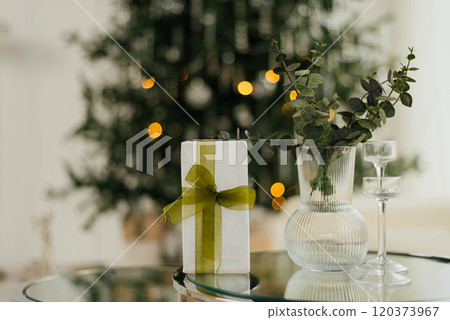 Christmas gifts placed in front of the Christmas tree 120373967