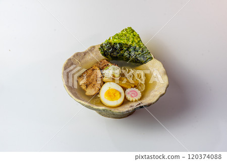 A delicious bowl of ramen being prepared  120374088
