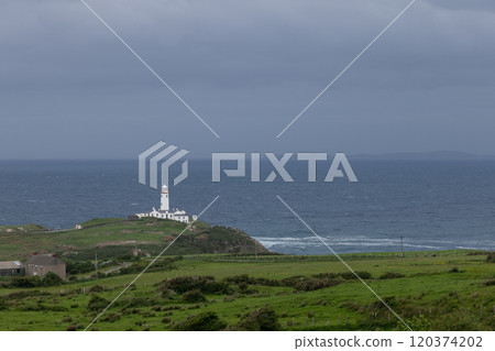 White Fanad Lighthouse against Atlantic Ocean green fields and rugged coastline of Donegal White Fanad Lighthouse against Atlantic Ocean green fields and rugged coastline of Donegal 120374202