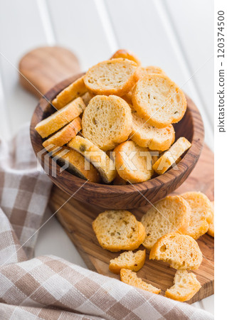 Sliced roasted bruschetta bread in bowl on white table. Sliced roasted bruschetta bread in bowl on white table. 120374500