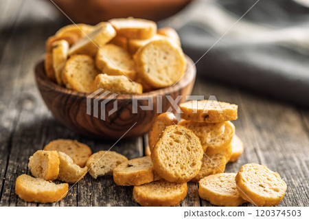 Sliced roasted bruschetta bread on wooden table. Sliced roasted bruschetta bread on wooden table. 120374503